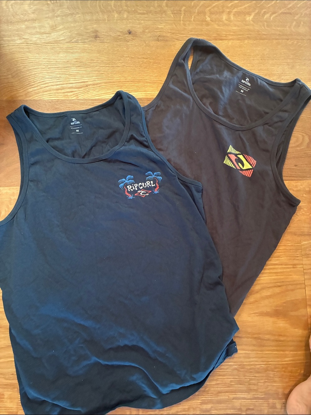 2 Rip Curl Navy Graphic Tank Tops - Pair in blue and black. Men’s M